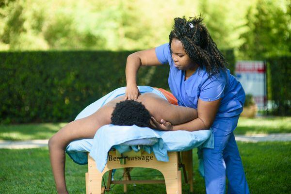 Focus and Care: The Gentle Intensity of Massage by Monique's Outdoor Therapy Session.