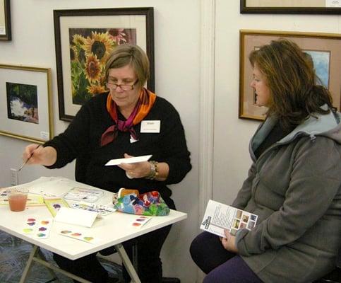 Clair Breetz, one of the Art Circle artists, demonstrates her technique during an ArtWalk. ©Connie Springer