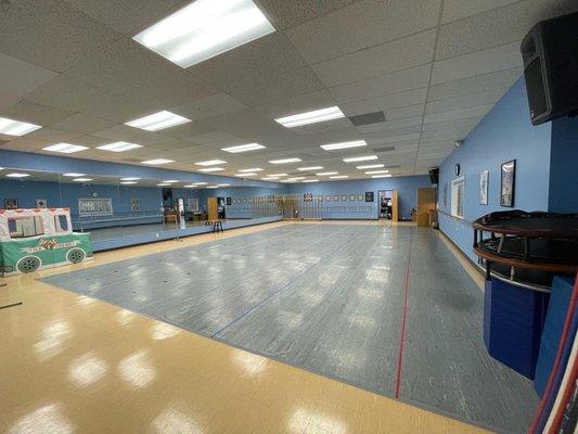 Room A - Stage size dance room with raised flooring and marley for dancers to practice.