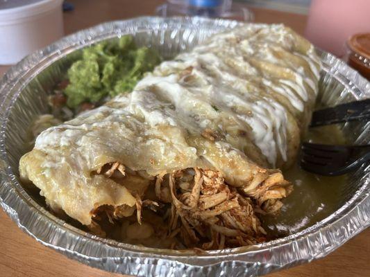 Tinga chicken wet burrito in green sauce with guacamole.... The very best around!!!!!!