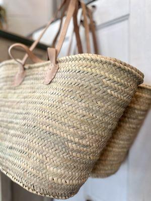 Hand woven french market baskets with leather straps - a timeless staple found at Hearth & Home Mercantile