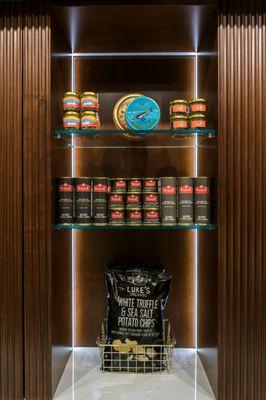 A view of a shelf at Marky's Caviar inside Grand Central station that has foie gras products and truffle chips at the bottom.