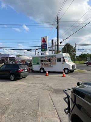 Taco and food trucks in the parking lot.