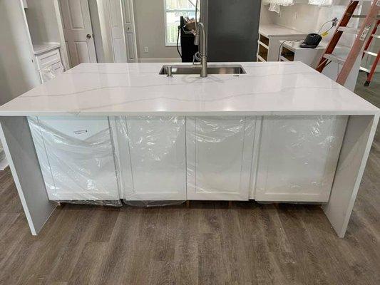 Calacatta Gold Quartz   Island with Waterfalls and White Shaker Cabinets