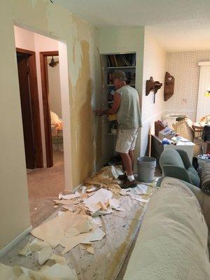 Andy Norris Painting , working taking off wallpaper in a house I am getting ready to sell. The owner lives in Ohio,  So Andy is painting.