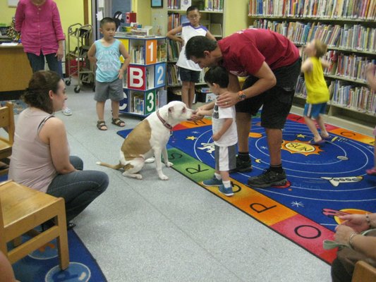 Teaching kids how to interact with dogs at local library.