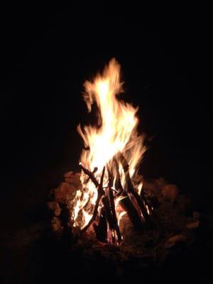 Campfire in the man made river rock fire pit.