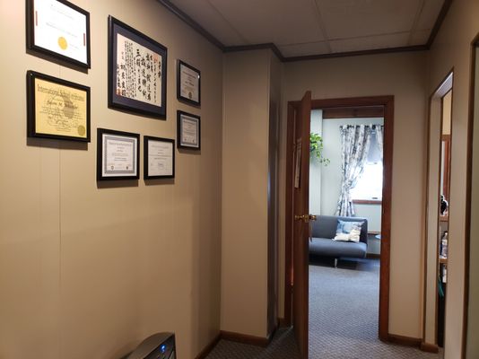 Hall from Lobby to treatment rooms with certifications for your review.