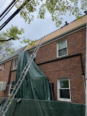 Removing old layers of shingles from mansard roof