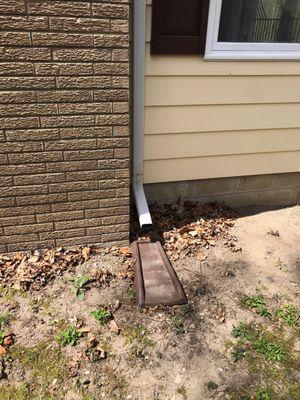 How far should downspouts extend from the house? 4 to 6 feet from the house but 10 feet if possible