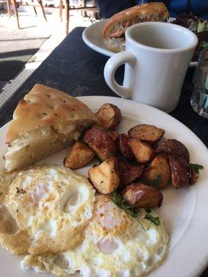 2 eggs over easy with potatoes and house focaccia bread