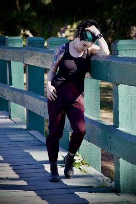 Model posing on wooden fence.