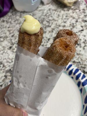 Churro with vanilla filling and two regular churros.