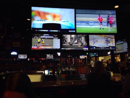 Bar area with a wall of TVs.