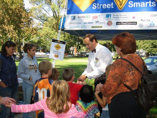 Magicians for kids. 
   Using magic to teach families how to be street smart when walking and riding their bikes.