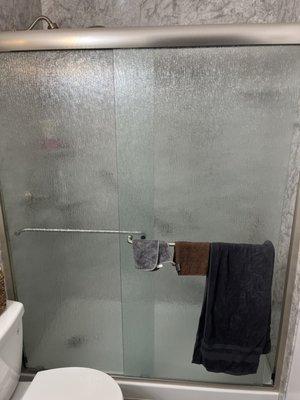 Walk in shower with frosted sliding doors