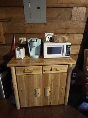 Buffett cabinet that houses dishes, Keurig. Placed against door first night.