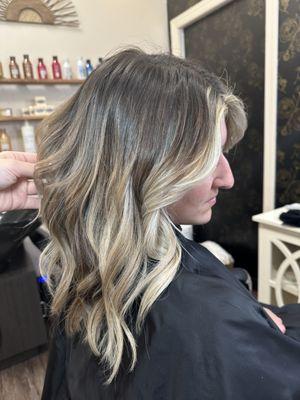 Very rooted balayage with bright blonde money piece .