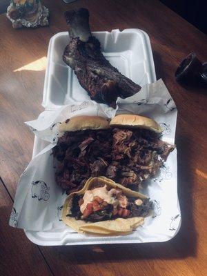 Clockwise from top: beef rib, pulled pork, barbacoa taco, brisket.