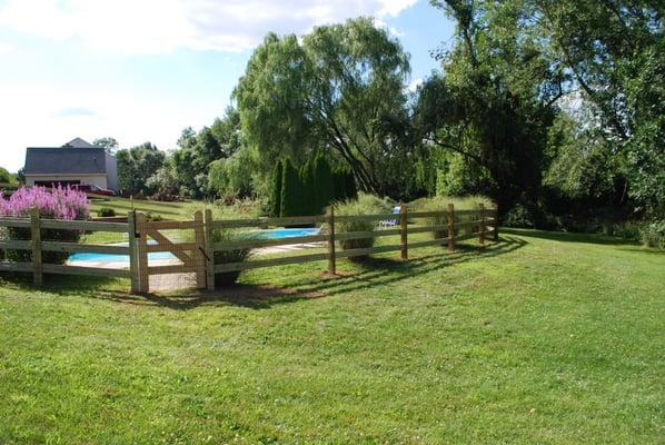 Three board Slip Board fence with black vinyl coated pool code wire