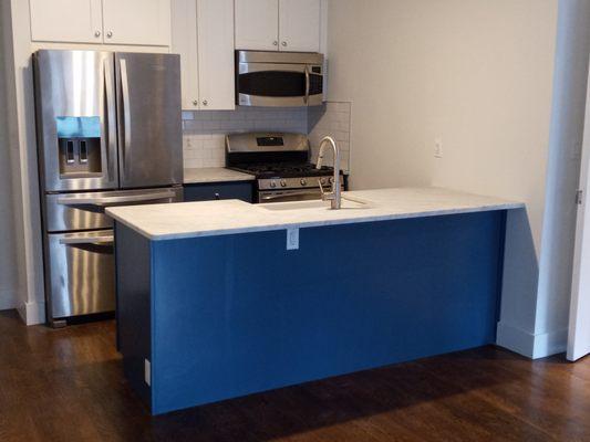 His team painted this blue kitchen peninsula