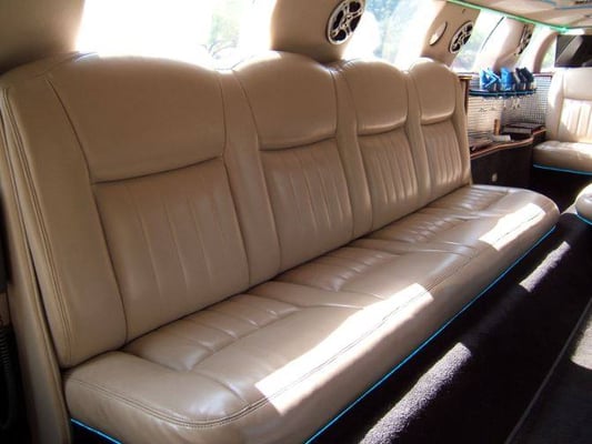 Lincoln Town Car Limo: A true show stopper, it's capable of seating 14 passengers, has two redwood bars, fiber optic and ambient lighting.