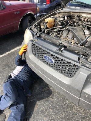 Richard working hard in a nearby parking lot.  Checking our serpentine belt and tensioner.