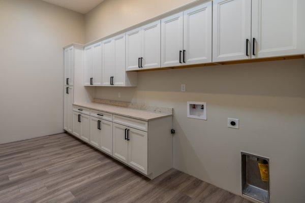 Laundry room:  White cabinets along with countertops for folding clothes.  Love this feature.