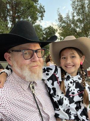 Dad and daughter in western wear