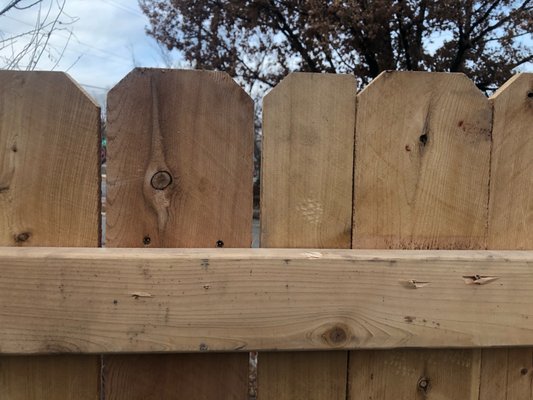 nail ends sticking through other side of fence, pickets cut in half in middle of gate, holes left from pickets being pulled off/renailed