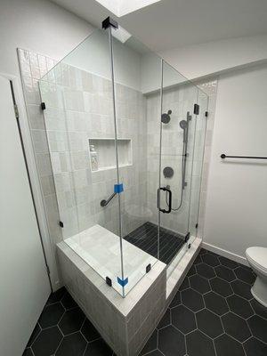 Four piece 1/2 inch frameless shower glass.