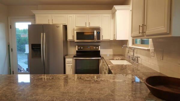 Kitchen remodeling. From top to bottom, Kitchen cabinet painting and back splash instalation.