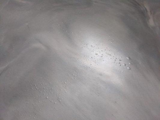 Epoxy coating, metallic matte with excessive blistering/bubbles due to incorrect prep of the concrete