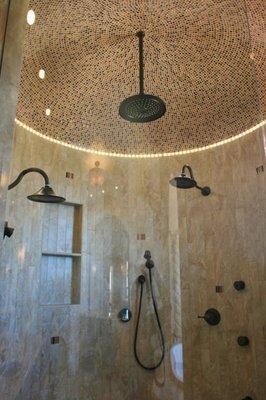 Round shower. All tile cut to strips to accommodate. Glass shower ceiling.