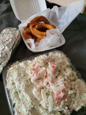 Bravo combo salad with tuna salad, chicken salad and seafood salad with garlic bread and onion rings.