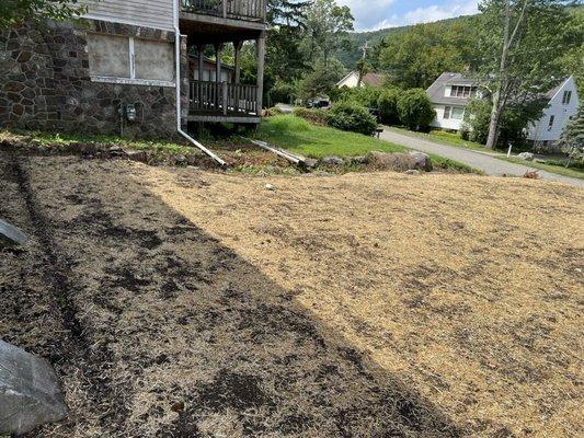 Yard was graded, top soil added, grass seeded and hay for new lawn.