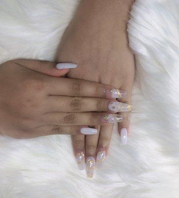 Milky white nails with gold flakes designs