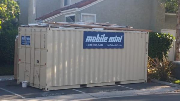 More garbage and wood pile on top of their giant mobile unit sitting in the middle of the guest parking lot