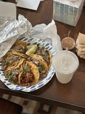 Carnitas, pastor and carne asada tacos and Horchata drink.