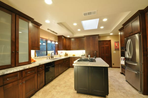 Kitchen with glazed finish on cabinets and distressed black island