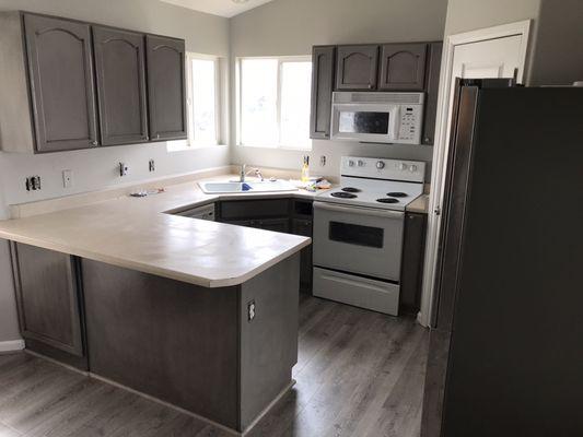 Gray base refinished cabinets with black glaze.