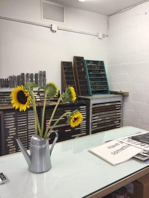 Inside the collaborative studio space including letterpress print making supplies