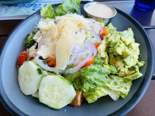 Cesar Caesar Salad with added cucumbers, tomatoes, and onion.