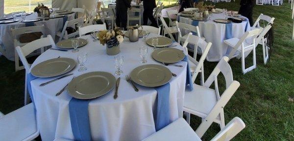 Round tables and white padded chairs. The white padded chairs are $1 more than regular white chairs but they look higher class