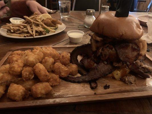 Brisket sandwich, and fried fish in the background.