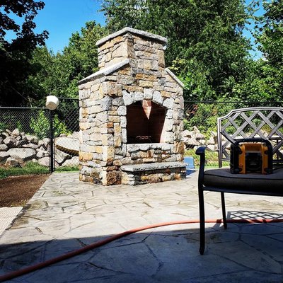 Custom outdoor fireplace roughly 9 feet high by 5 feet wide.