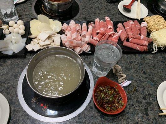 Bone broth hot pot, lamb, pork belly, beef, potato slices, mushrooms, quail eggs, squid