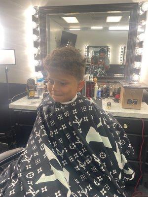 My son getting his haircut by chucho!