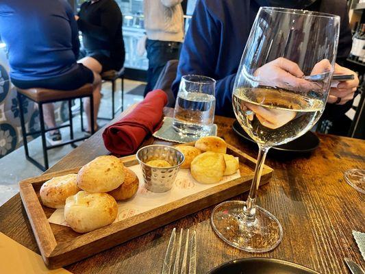 Puffed cheese bread and glass of Chenin Blanc