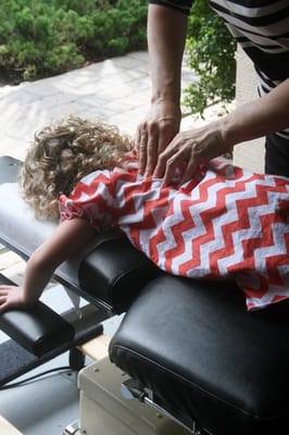 Child getting adjusted at Palm Coast Chiropractic Center.